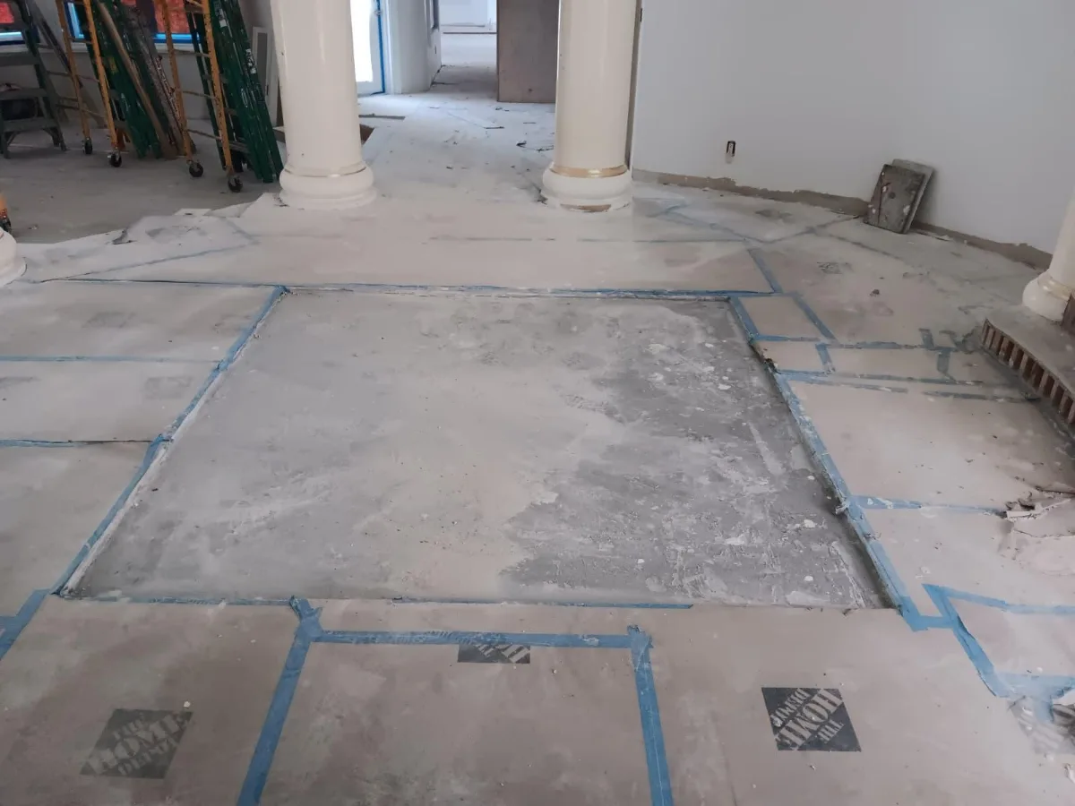 Prepared floor area marked out with blue tape, before the mosaic installation