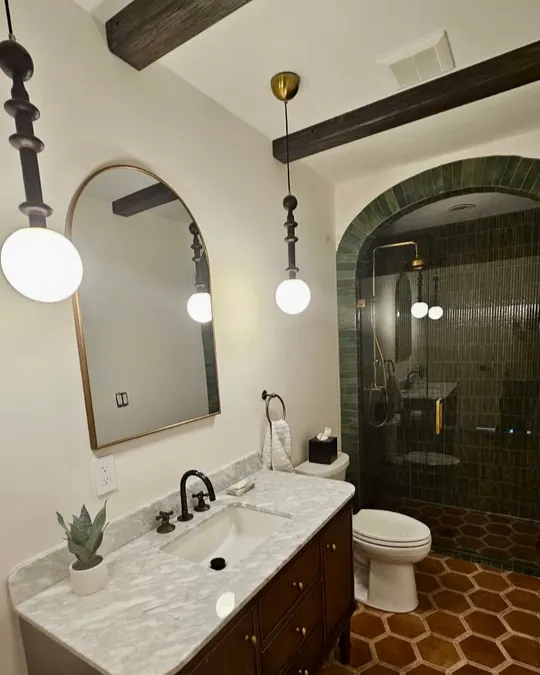 After: Bathroom with arched green-tile shower