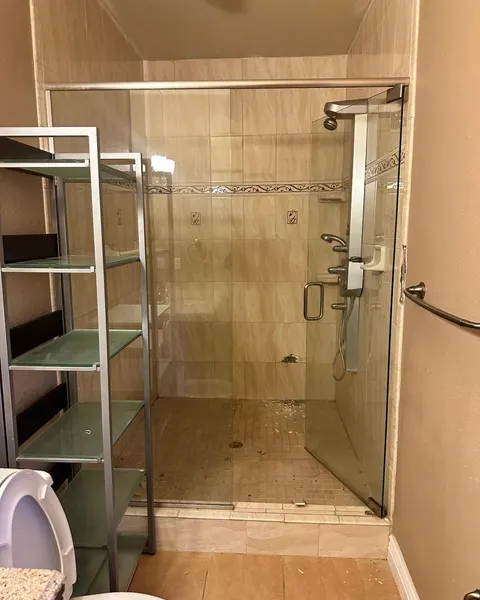 Before: Walk-in shower with marble-look tile