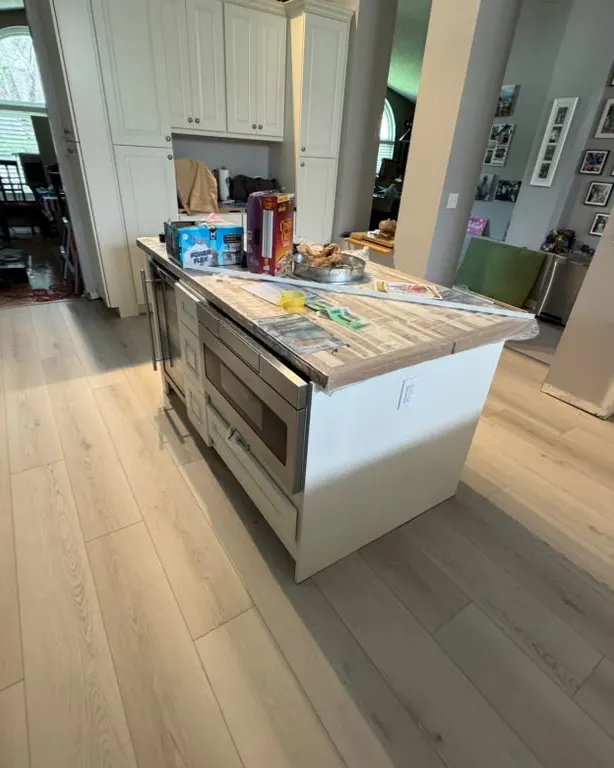 Finished: Light plank flooring in an open kitchen