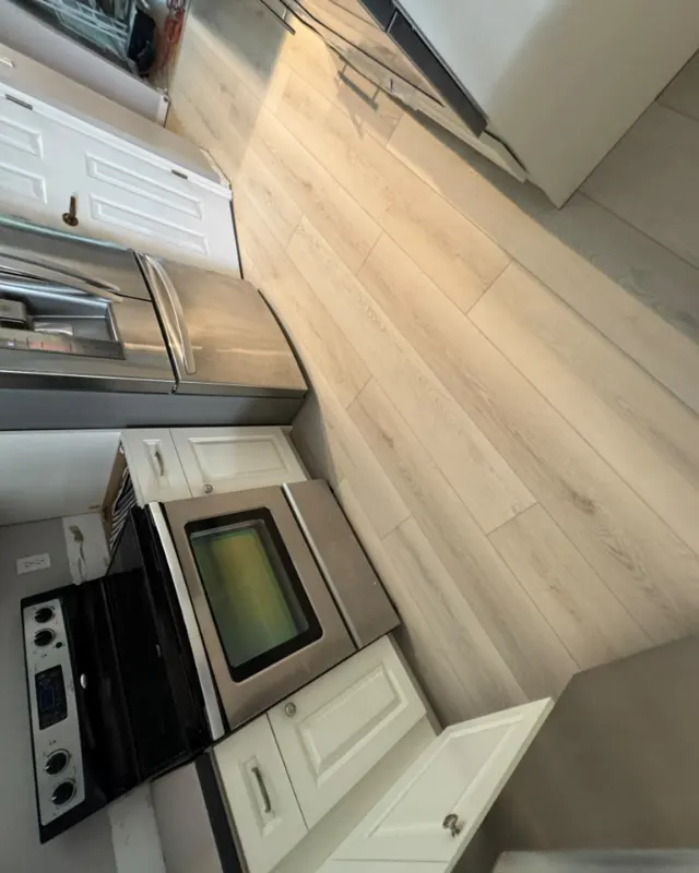 Finished: Light plank flooring in an open kitchen
