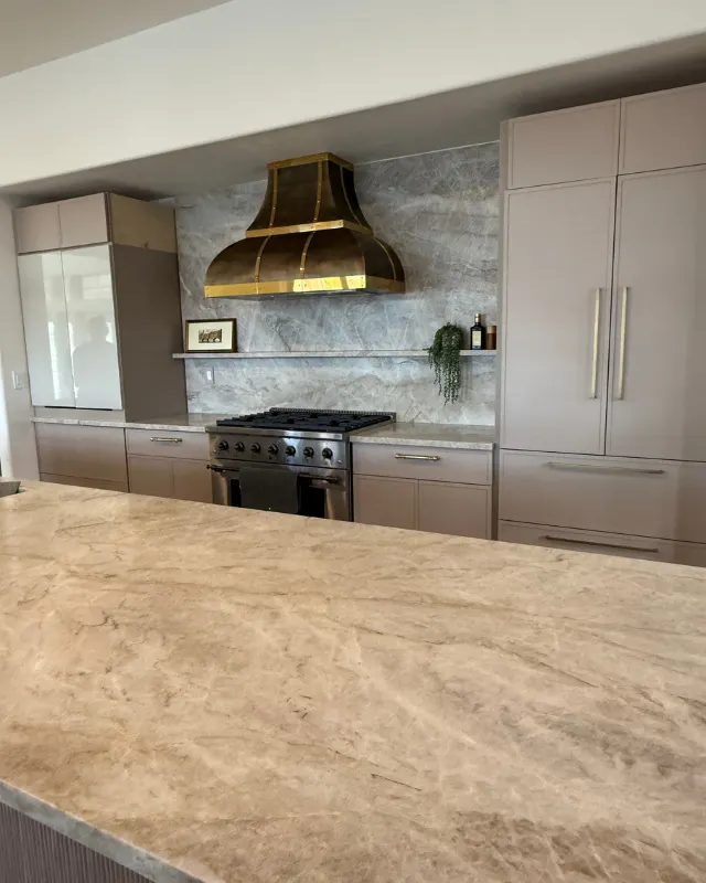 After: Kitchen with brass hood & stone backsplash