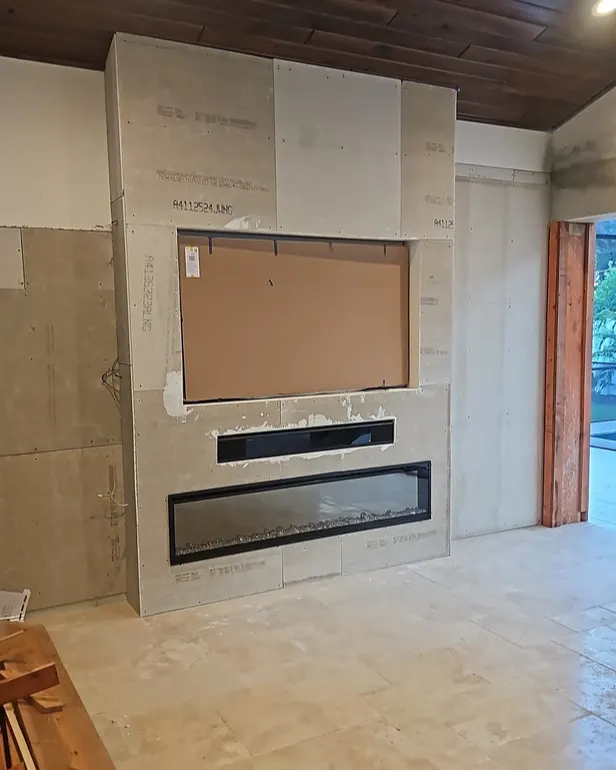 Before: Living room with fireplace & stone media wall